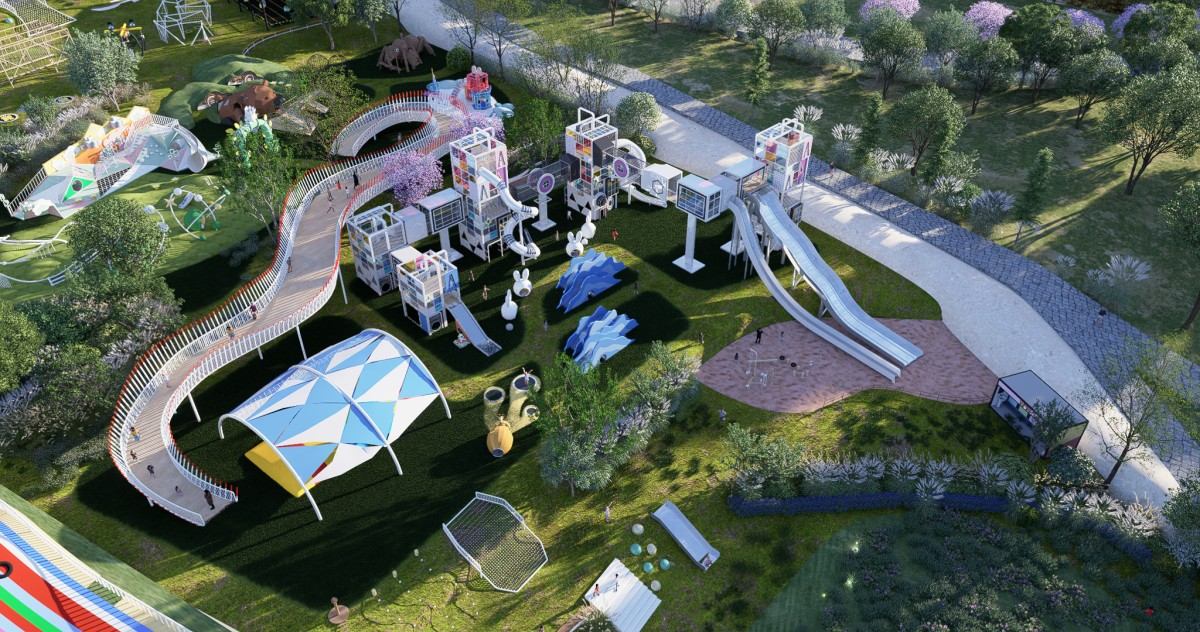 aerial view of climbing towers with slides, a shade canopy and a sand pit