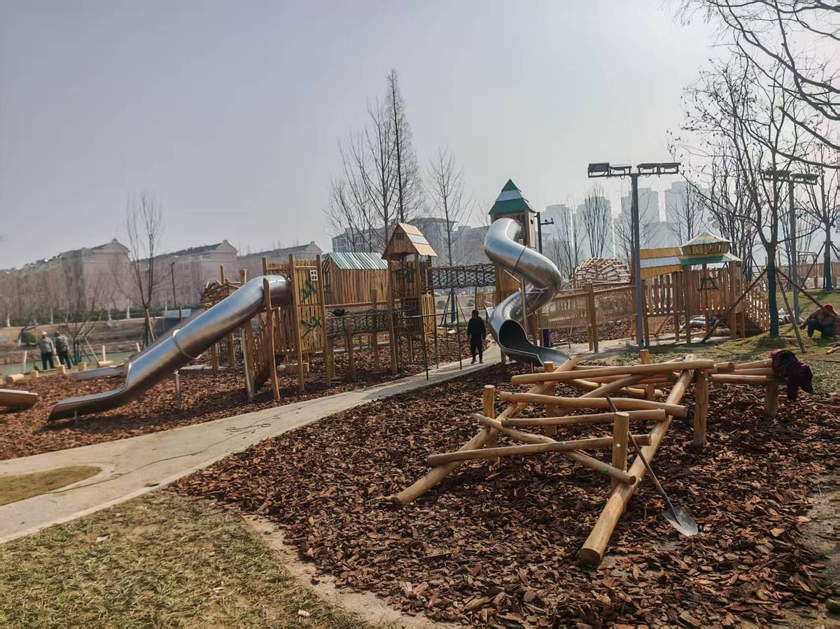 timber post and stainless steel spiral slide set combined with low climbing logs for young children timber post and stainless steel spiral slide set combined with low climbing logs for young children
